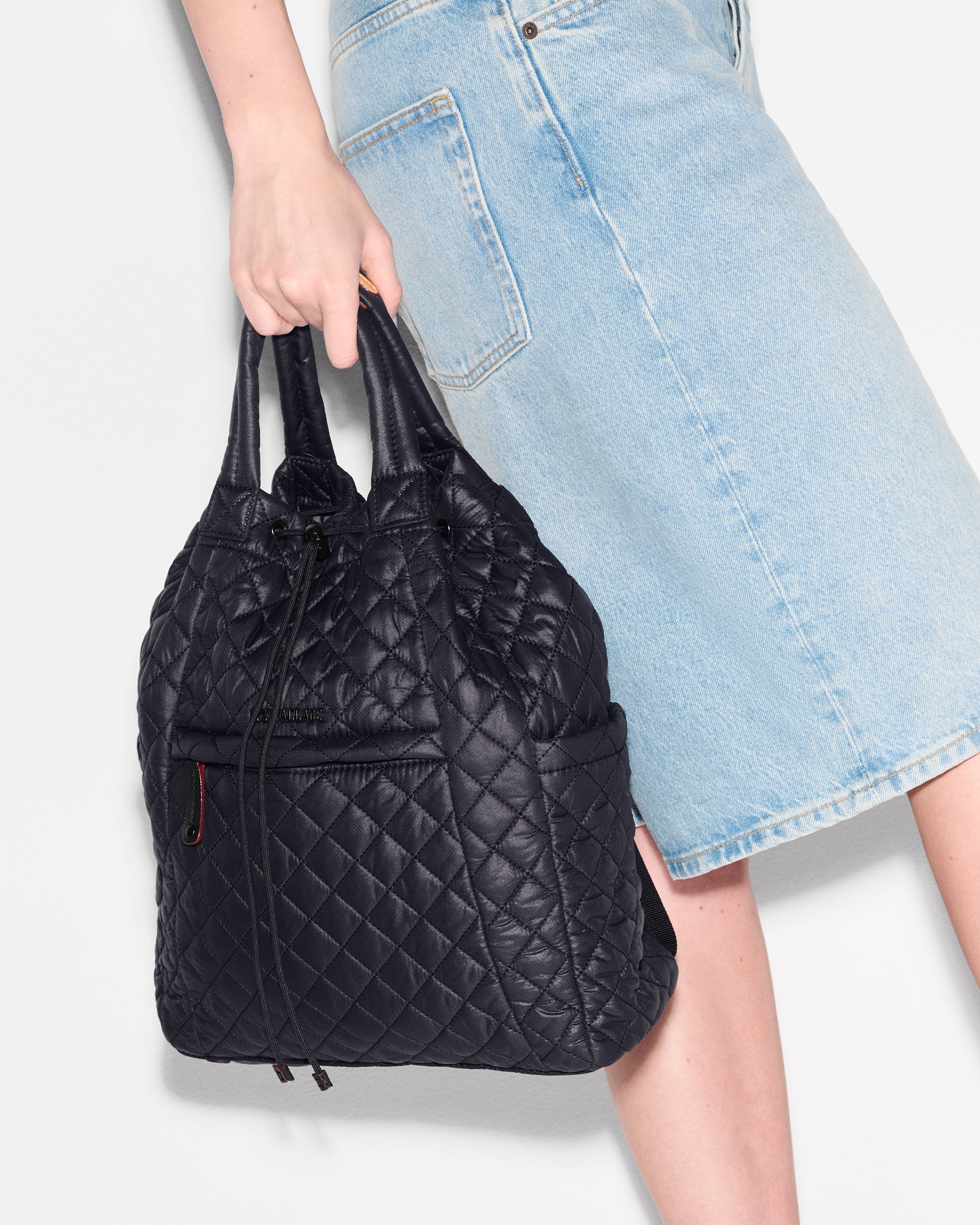 Person holding MZ Wallace Metro Convertible Backpack in Black