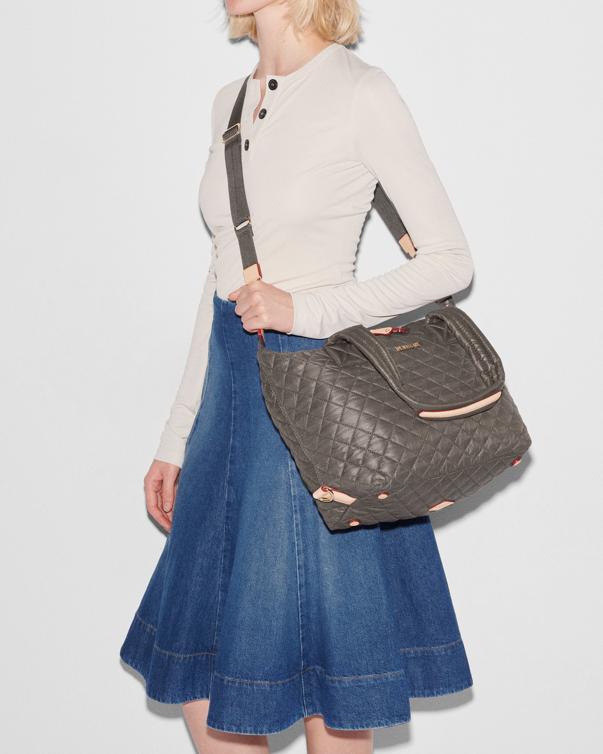 Woman holding MZ Wallace Dark Gray Crossbody Bag 