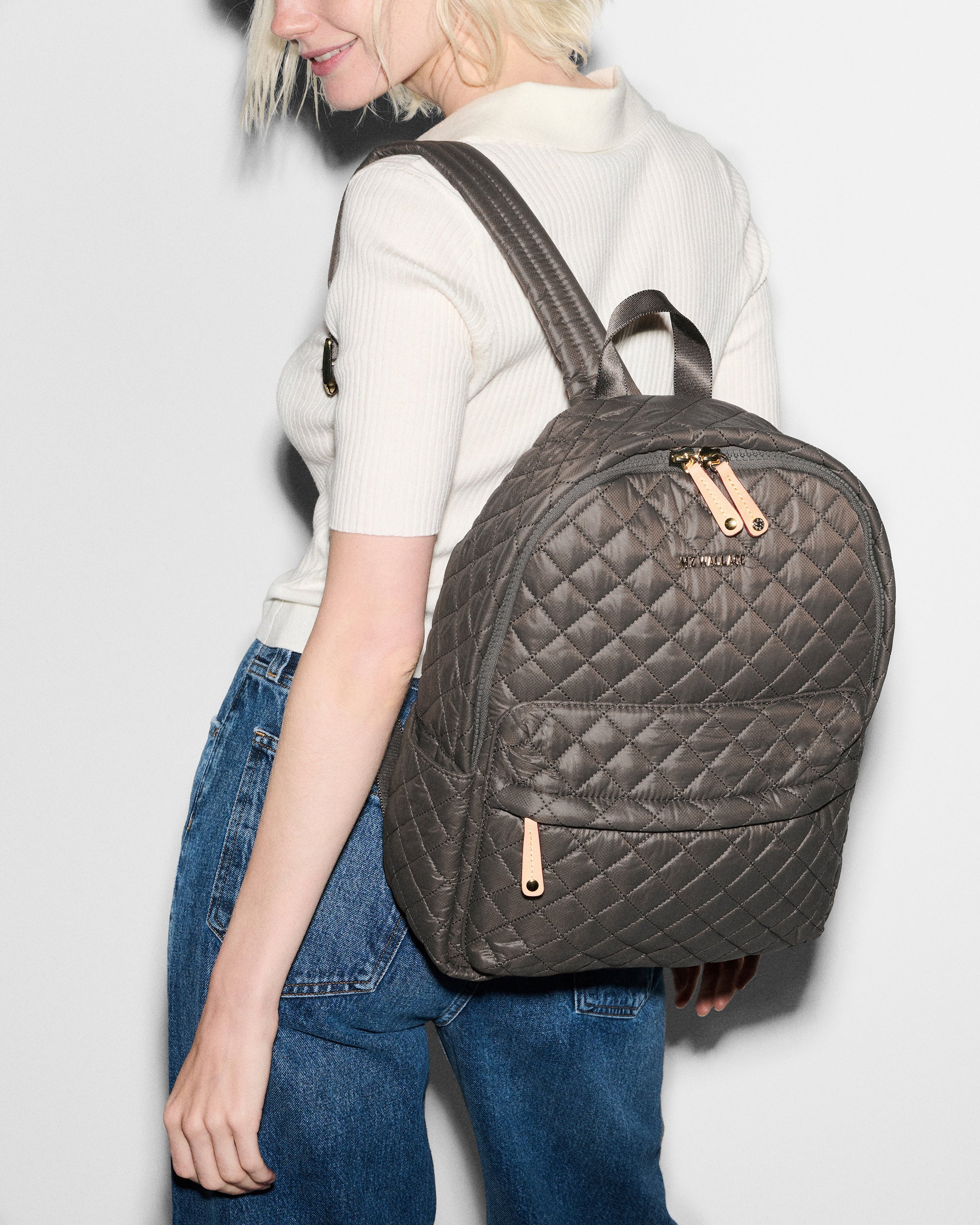 MZ Wallace Gray Quilted Backpack on woman's back