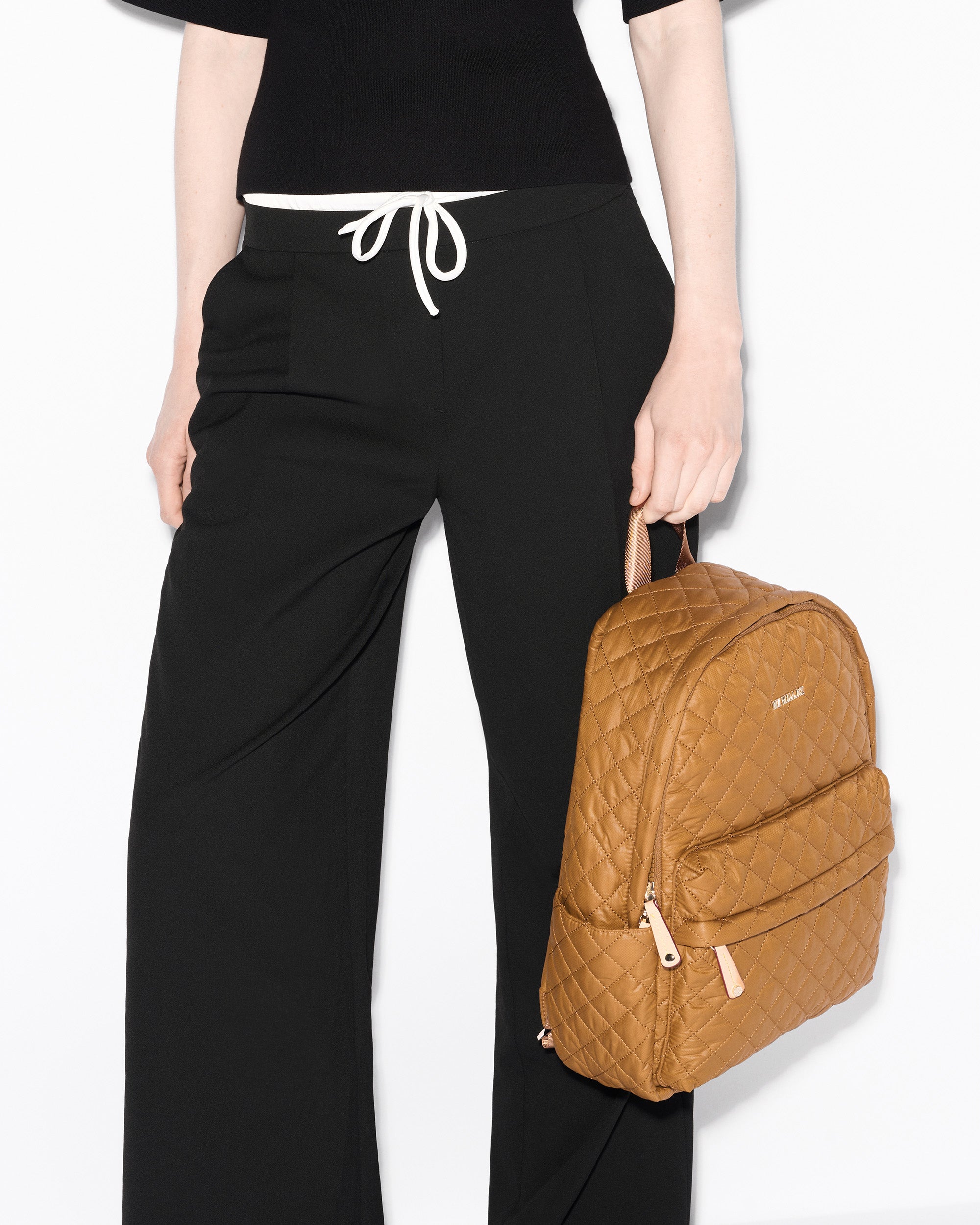 Woman holding MZ Wallace Amber Backpack 