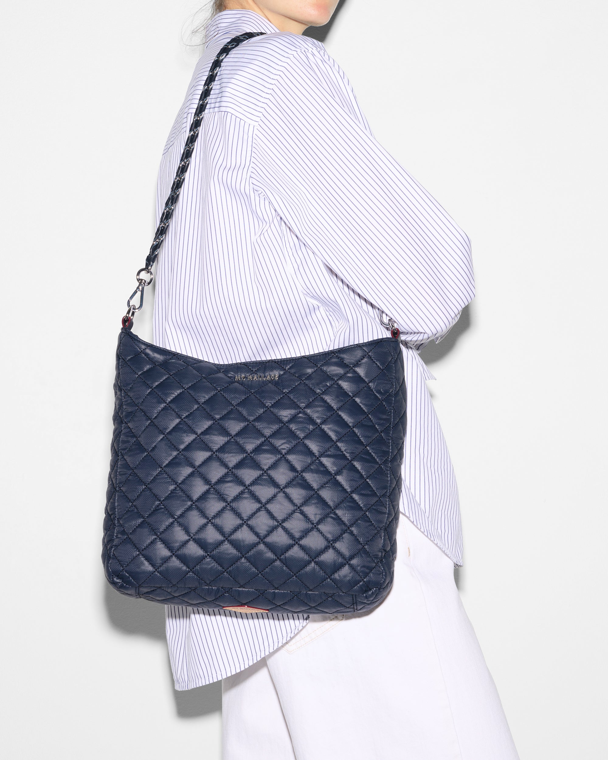 Woman holding MZ Wallace Navy Quilted Handbag on shoulder