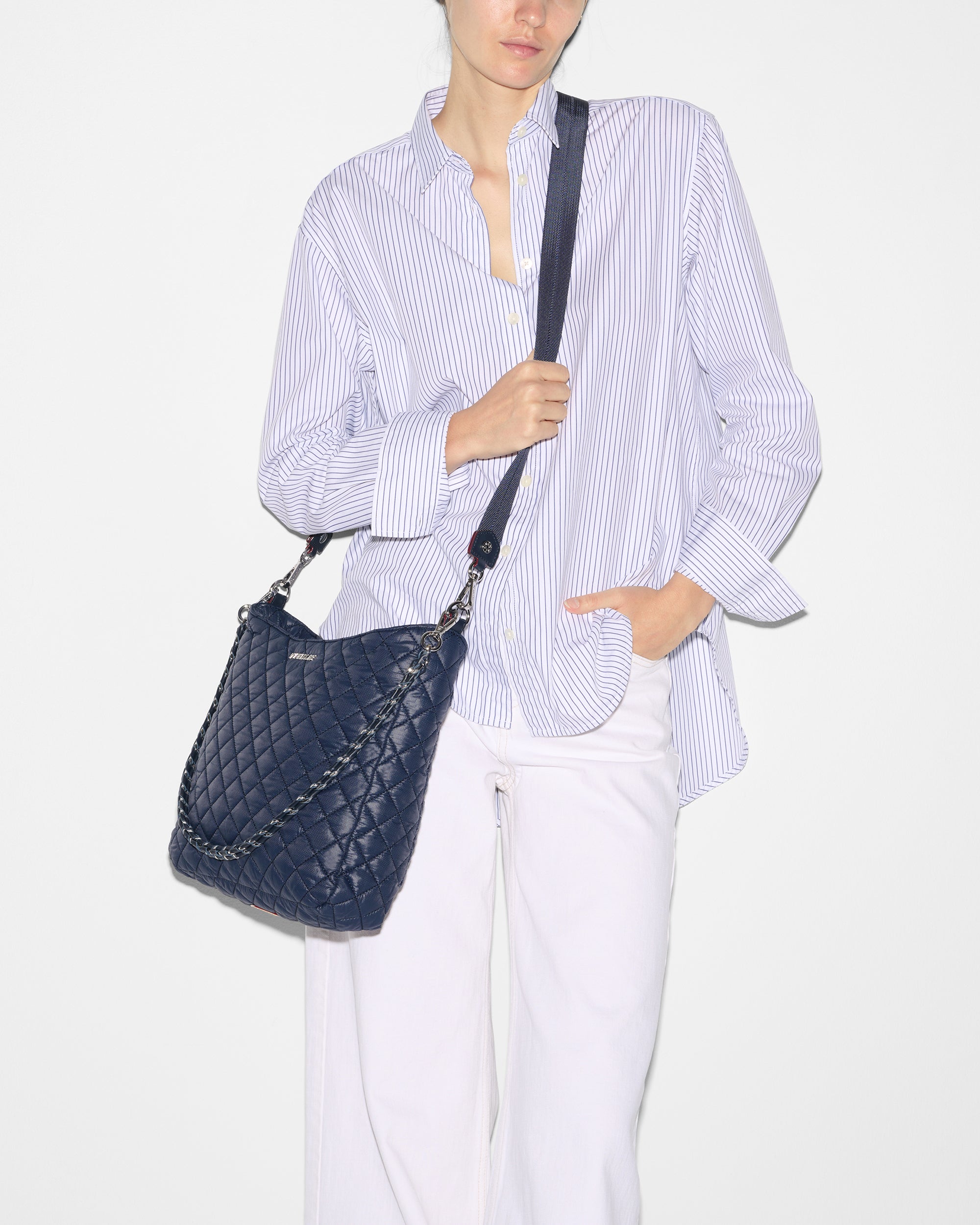 Woman wearing MZ Wallace Navy Quilted Handbag as crossbody