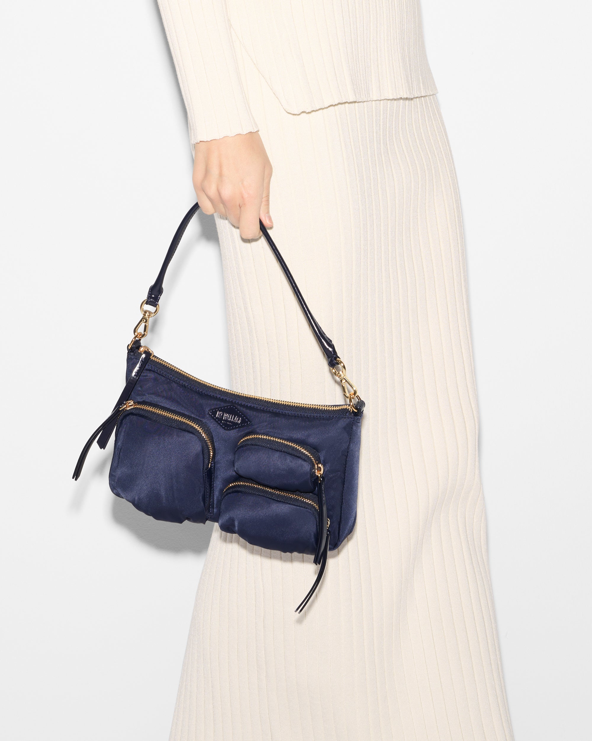 Woman holding MZ Wallace Blue Shoulder Purse in hand