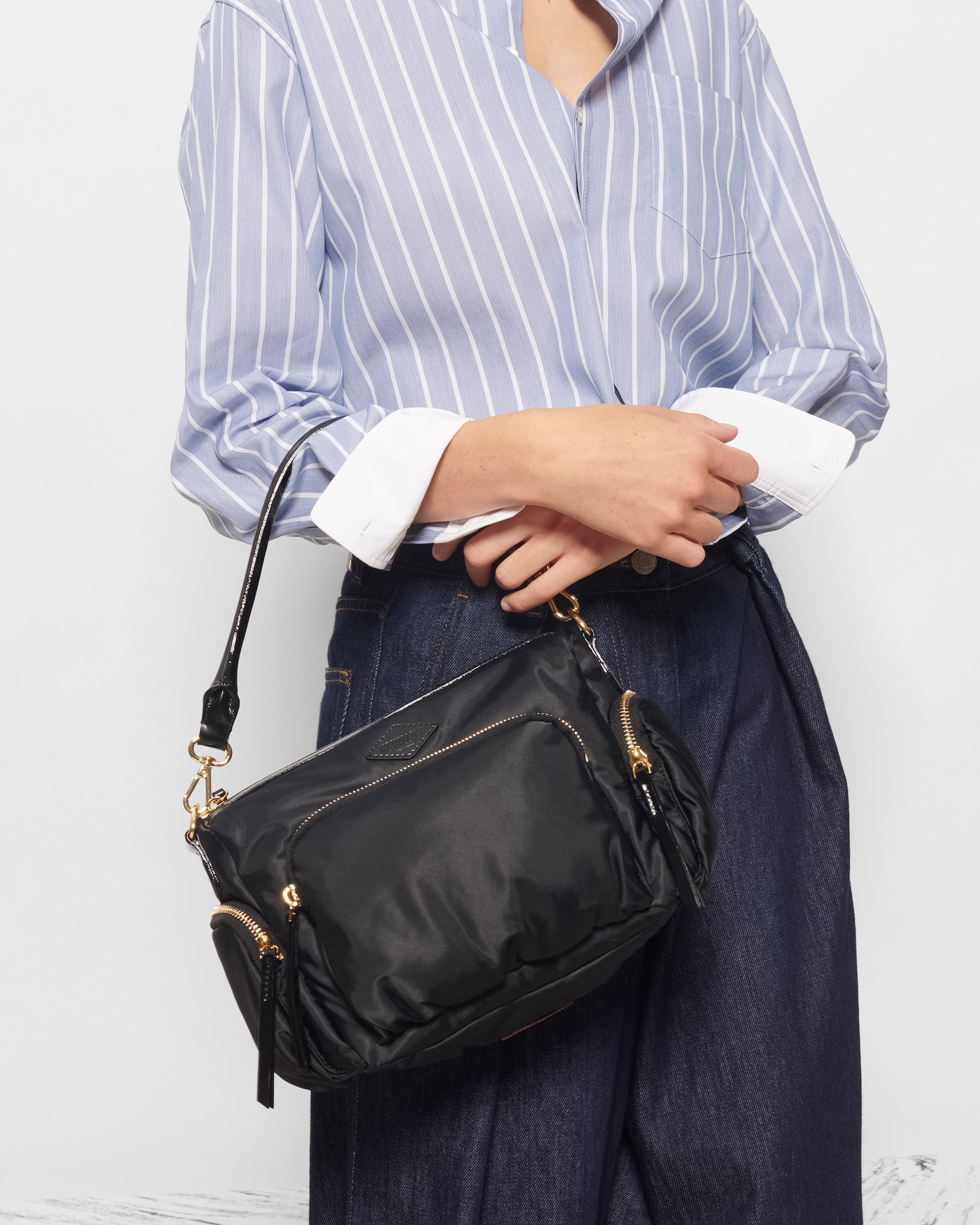 Woman holding MZ Wallace Black Nylon Crossbody