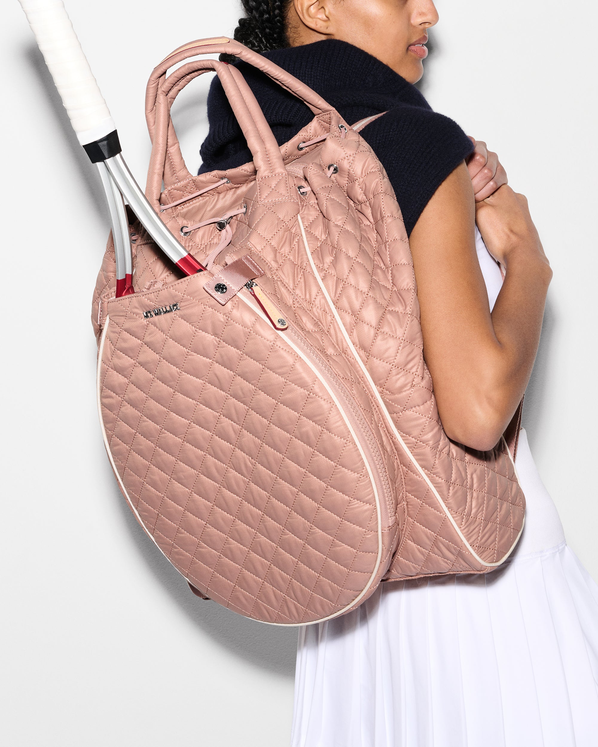 Woman wearing MZ Wallace Pink Tennis Racquet Bag on back