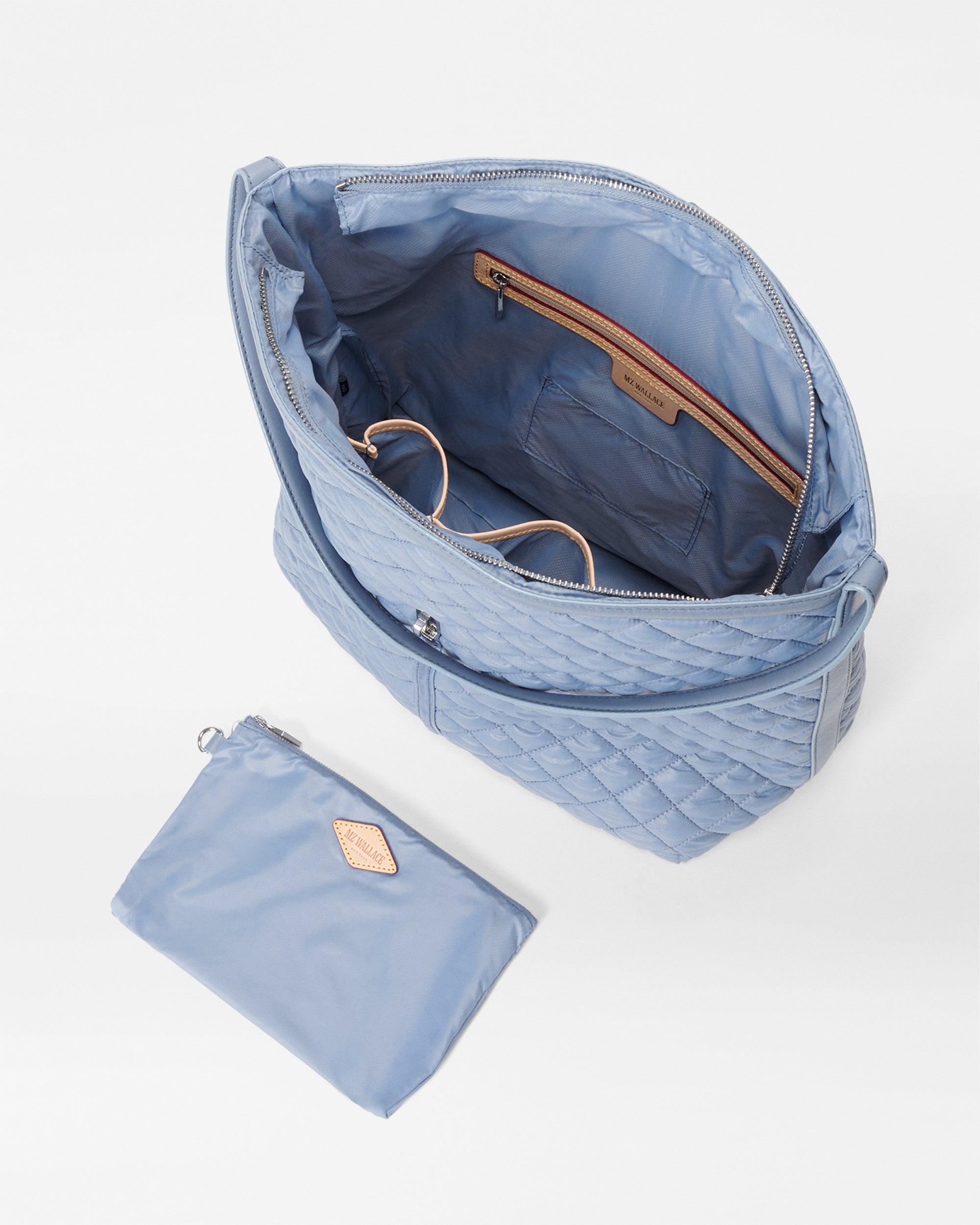 Inside view of MZ Wallace Baby Blue Shoulder Bag with accessories