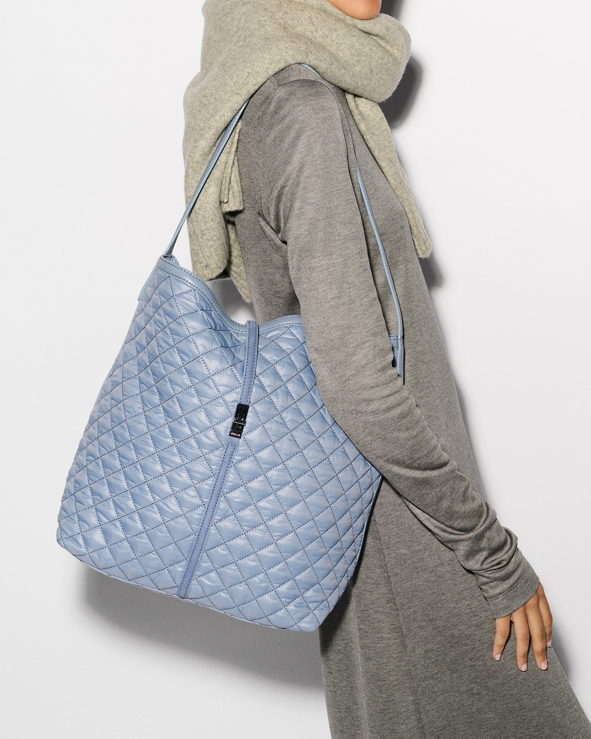 Woman holding MZ Wallace Baby Blue Shoulder Bag on shoulder