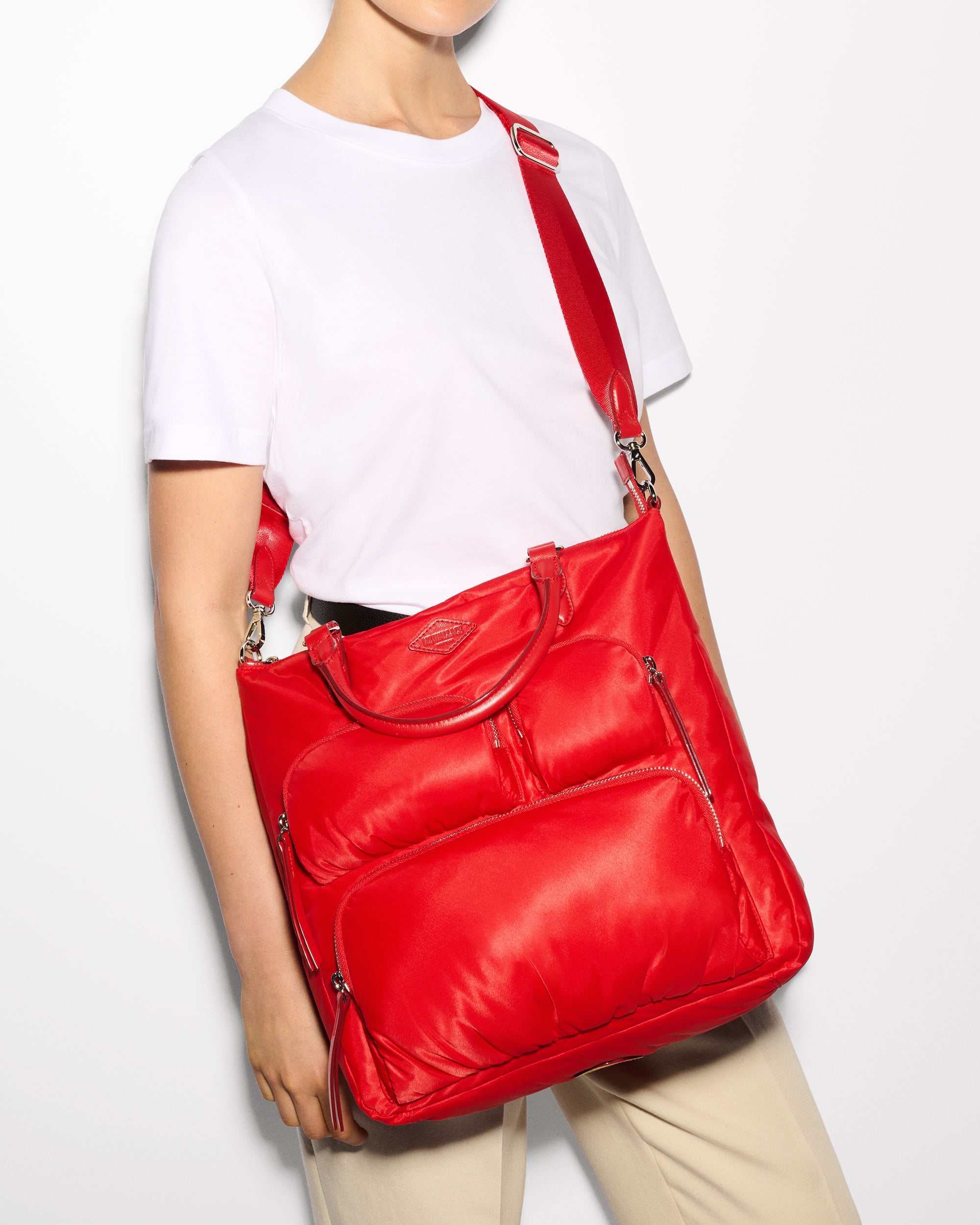 MZ Wallace Cherry Red Backpack worn as a crossbody