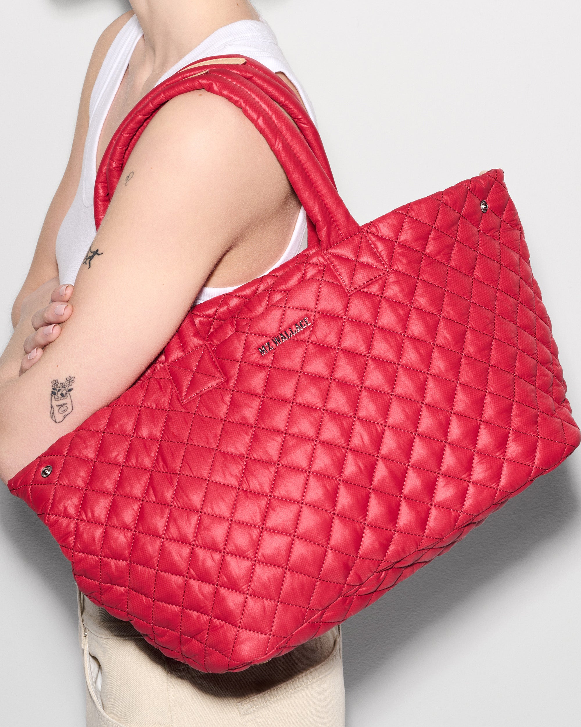 MZ Wallace Red Work Bag on woman's shoulder