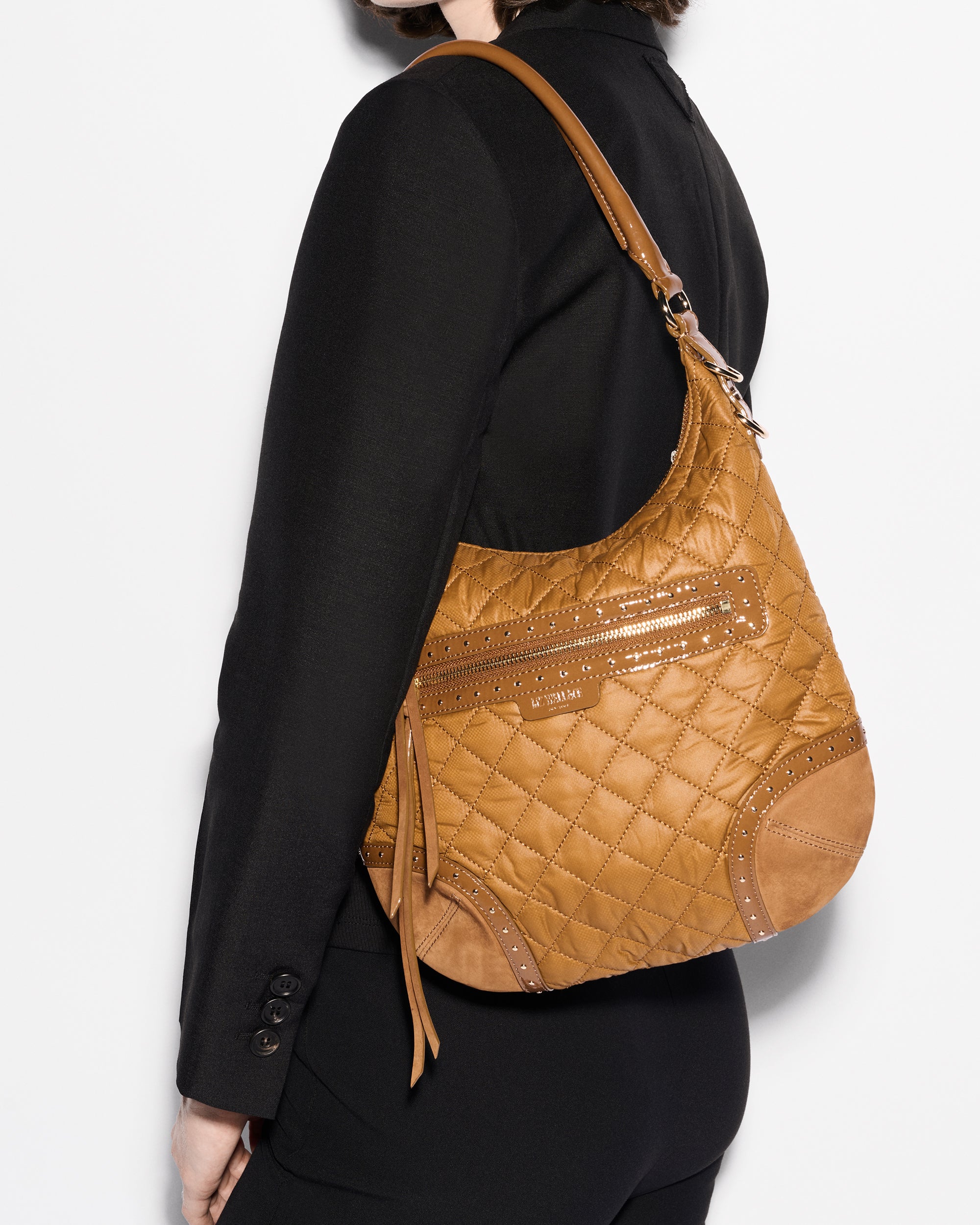 Woman holding MZ Wallace Amber Shoulder Bag on shoulder