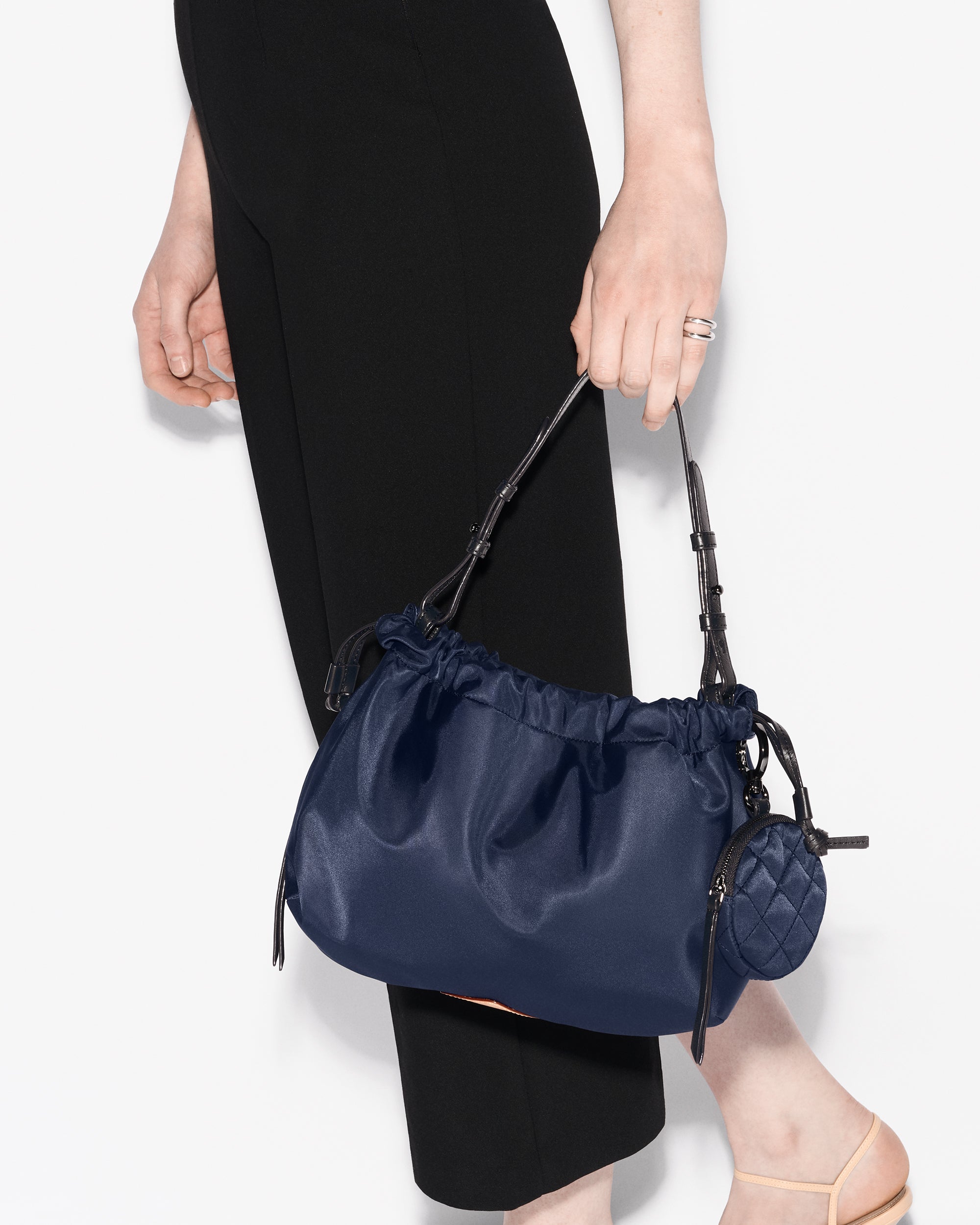 Woman holding MZ Wallace Blue Shoulder Bag in hand