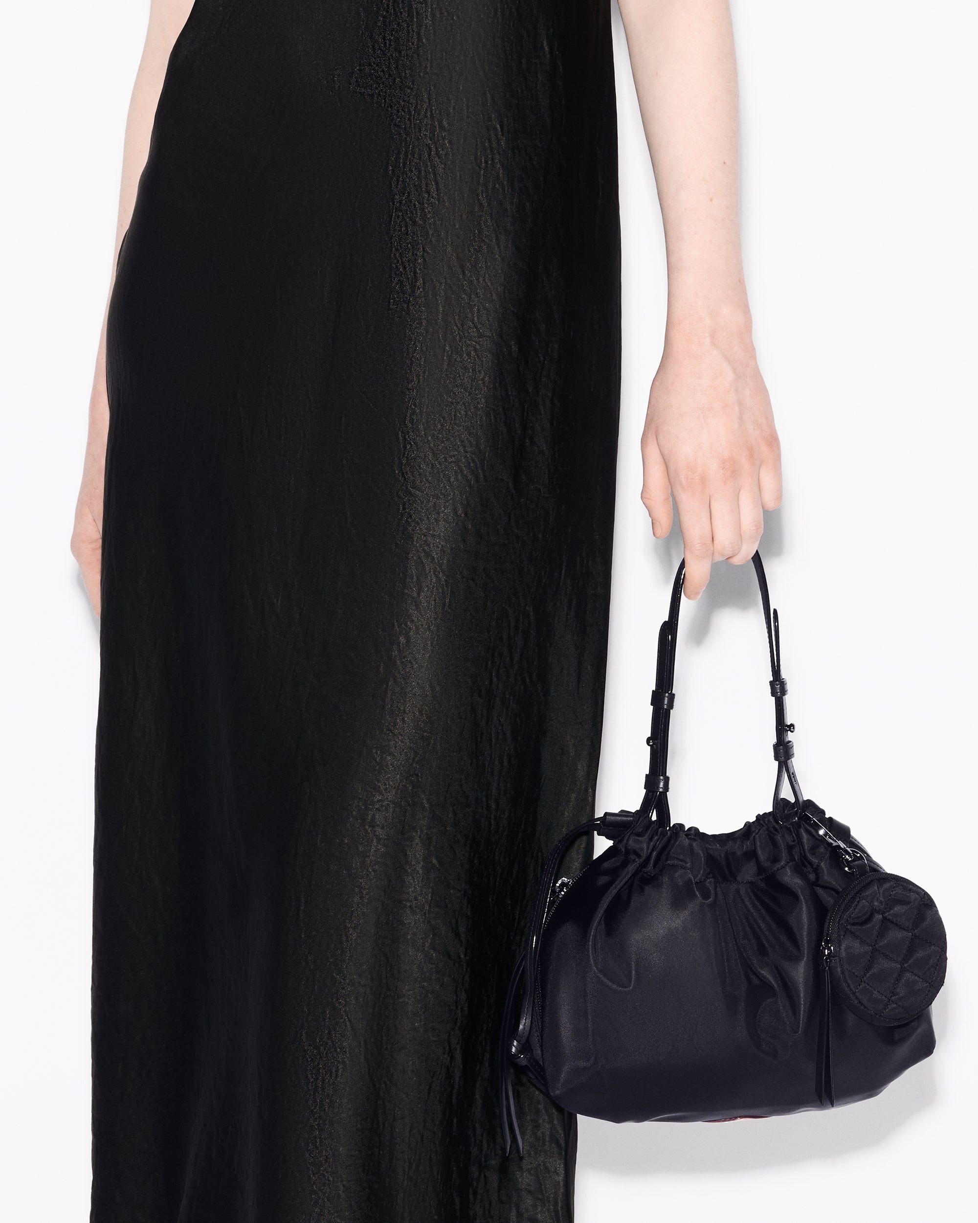 Woman holding MZ Wallace Black Slouchy Shoulder Bag in hand