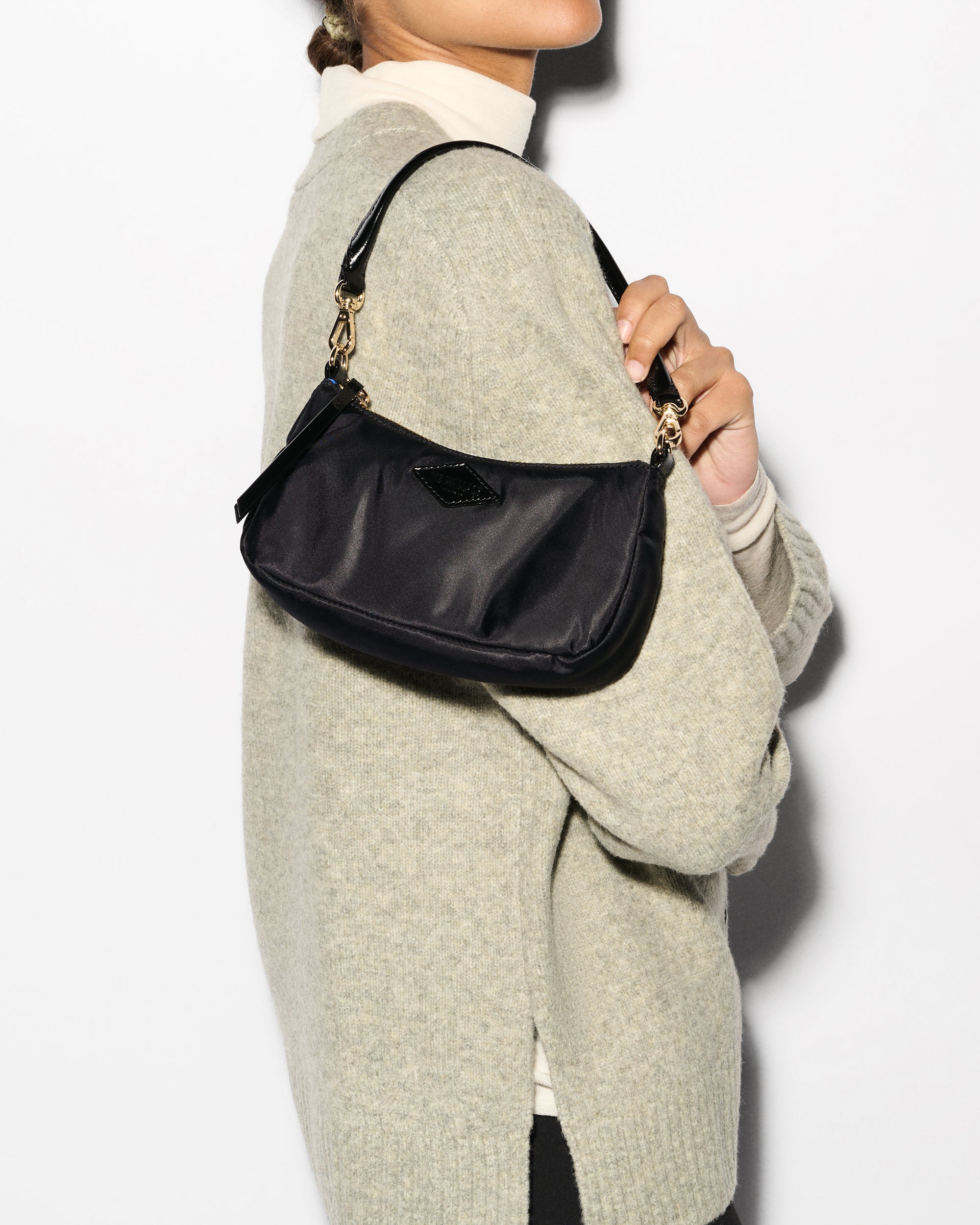MZ Wallace Black Mini Shoulder Bag floating on woman's shoulder