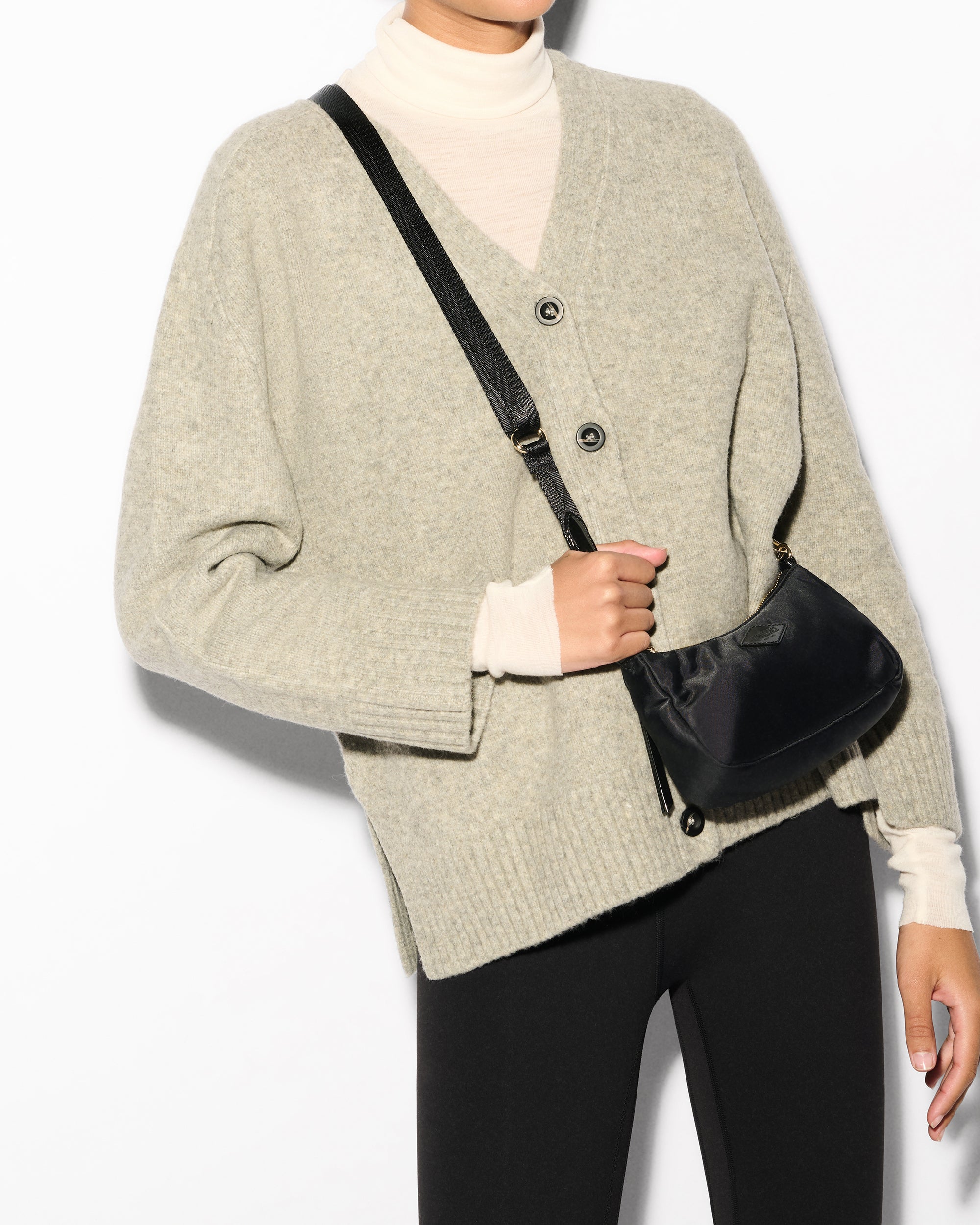 MZ Wallace Black Mini Shoulder Bag across woman's body for crossbody wear