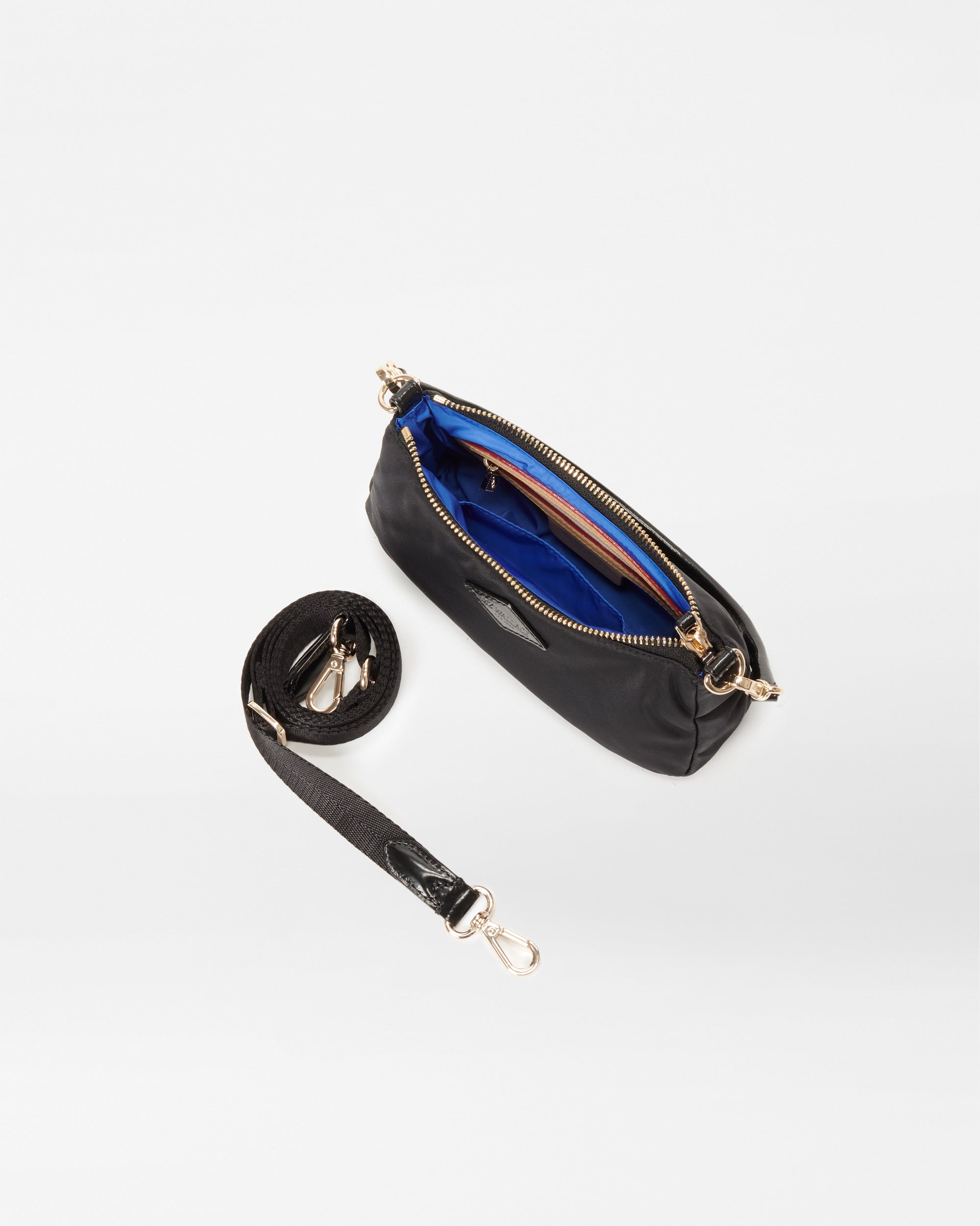 MZ Wallace Black Mini Shoulder Bag opened with crossbody strap accessory next to it