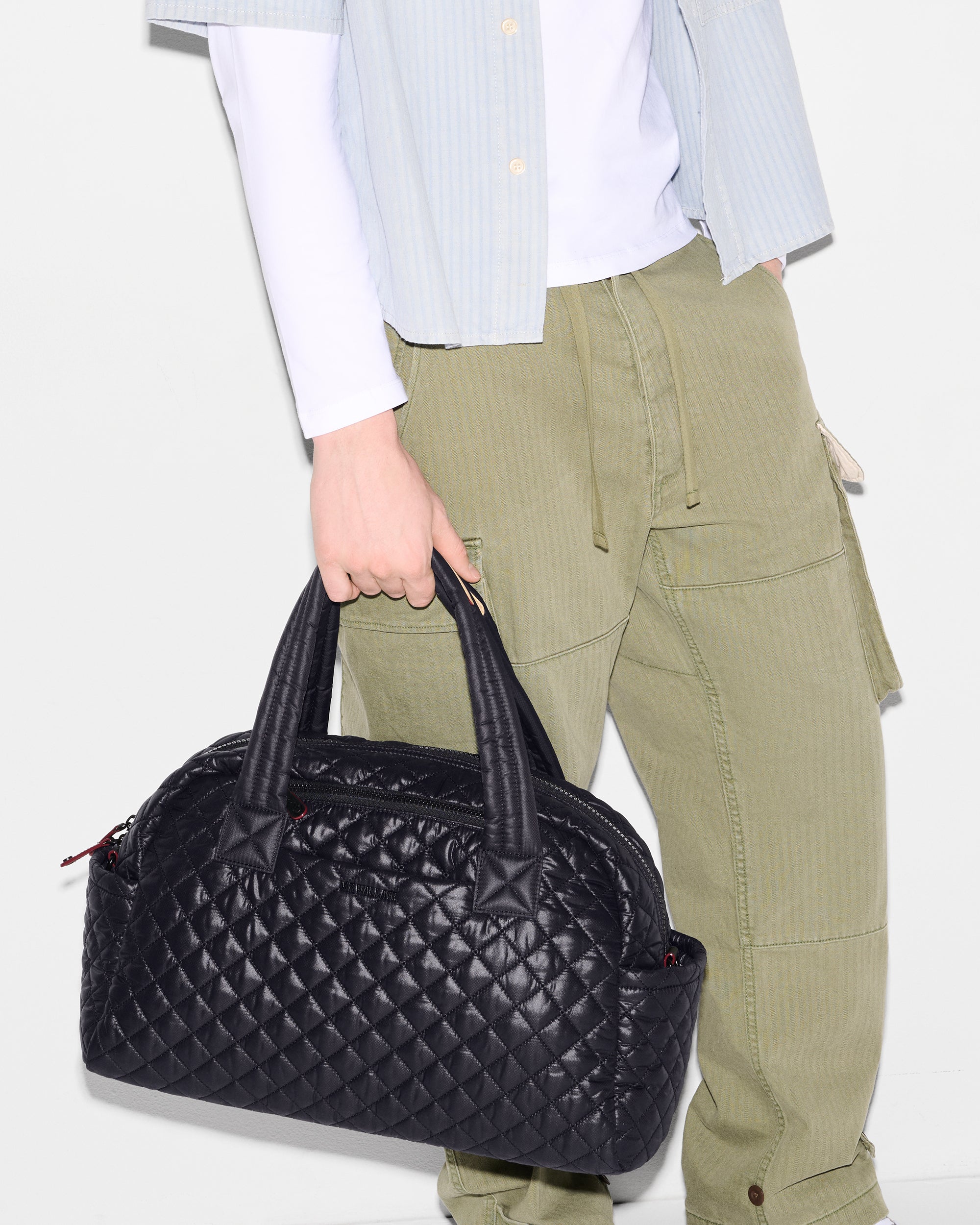 MZ Wallace Black Travel Duffle Bag held in hand