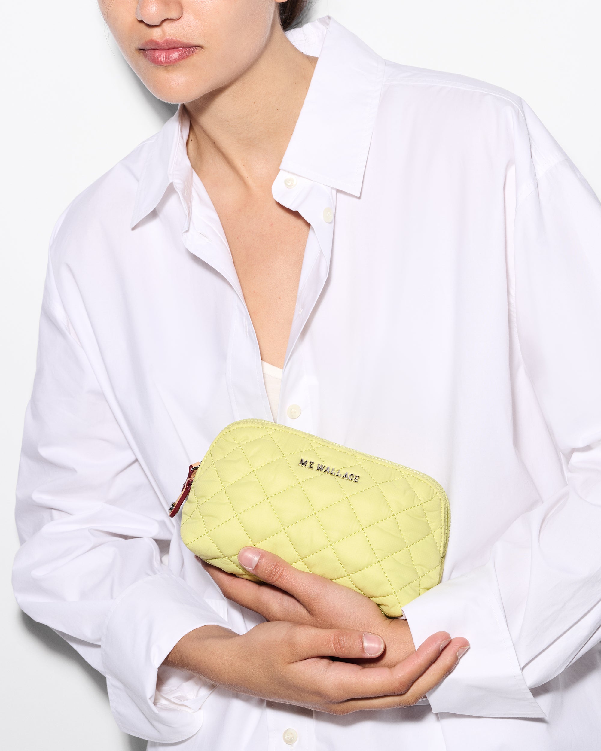 Model Holding Green Cosmetic Bag