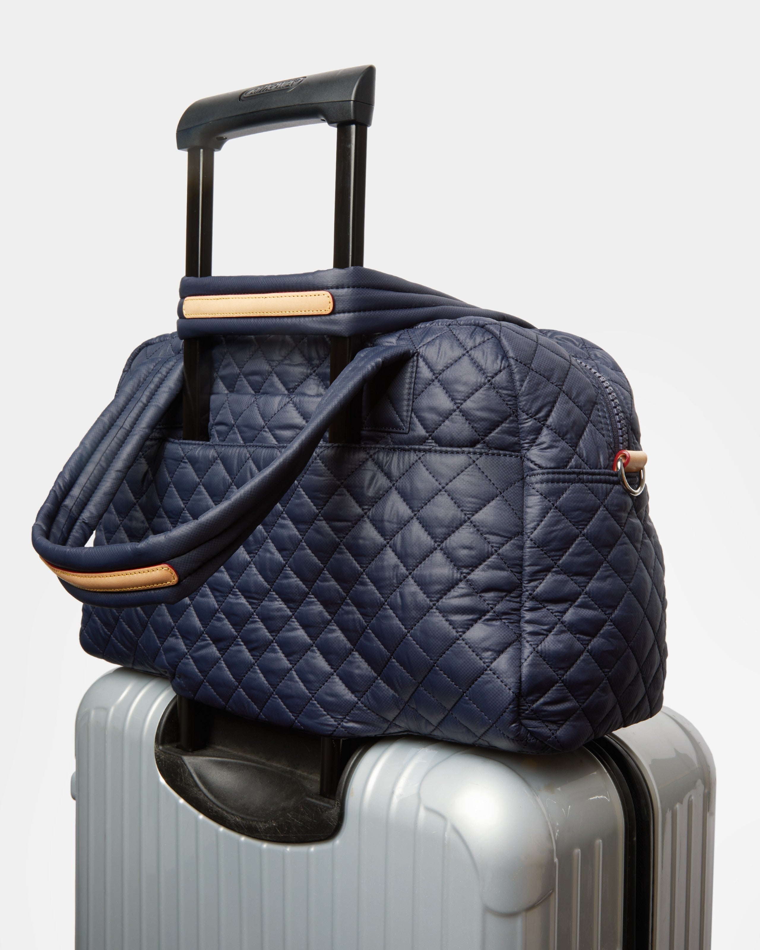 MZ Wallace Navy Blue Carry-On Travel Purse on luggage