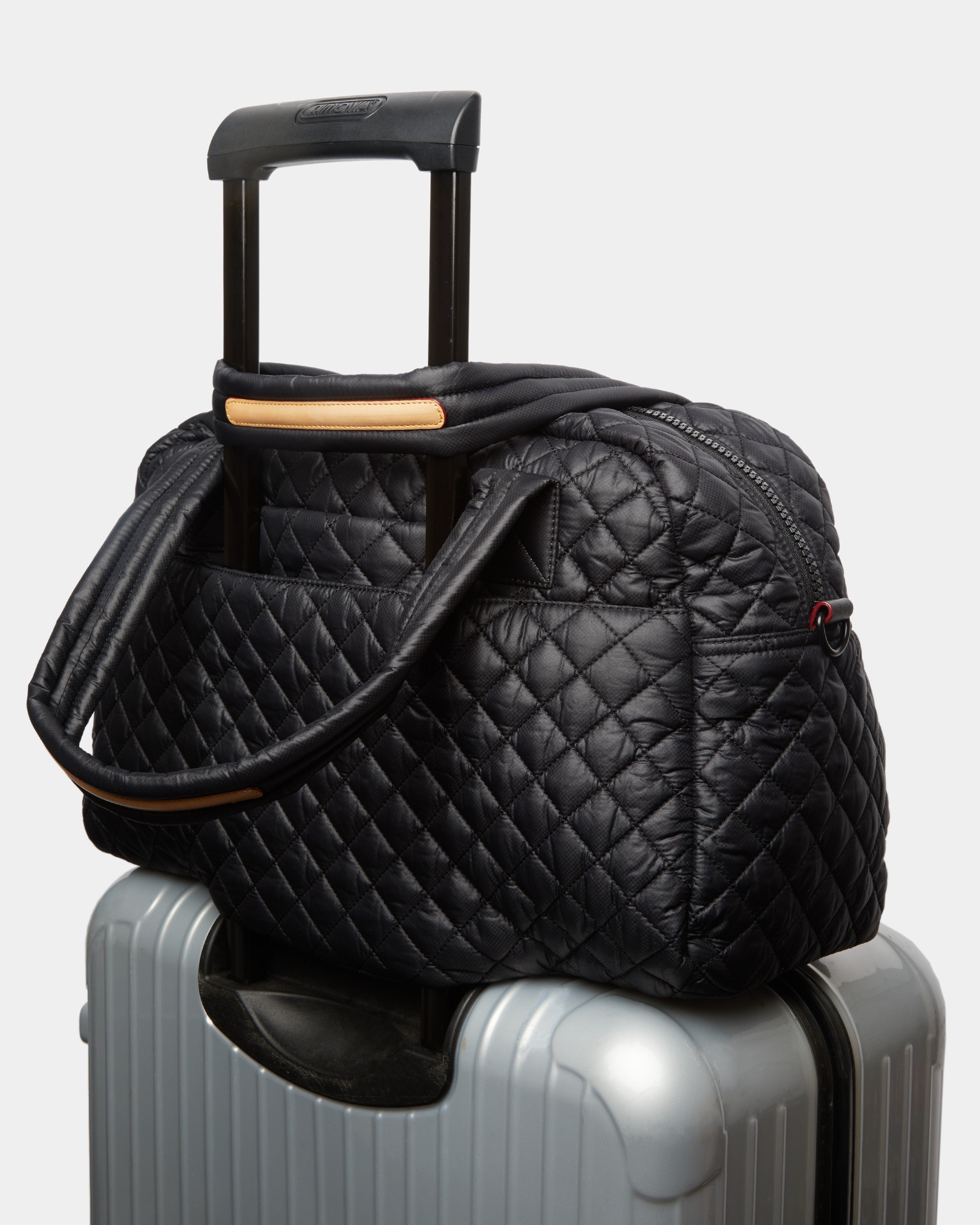 MZ Wallace Black Quilted Duffle Travel Bag on luggage